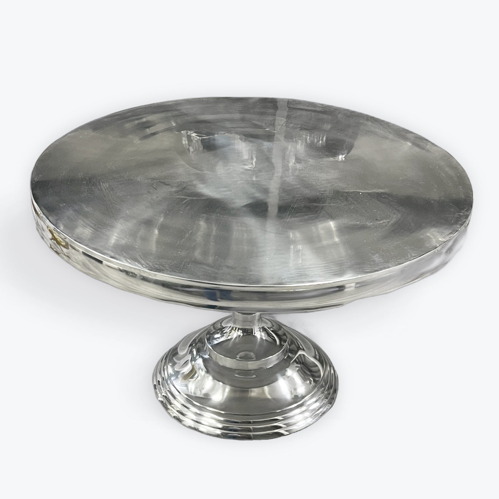 A shiny silver cake stand with a smooth surface and a sturdy base.