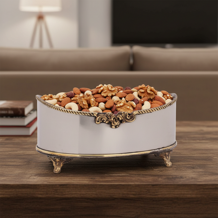 Oval bowl filled with walnuts, almonds, and cashews.