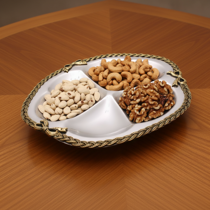 An oval dish with cashews, walnuts, and pistachios.